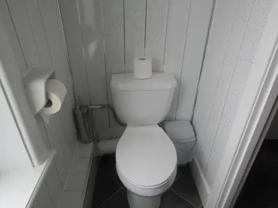 a bathroom with a toilet and a roll of toilet paper at Alderley Hotel Blackpool in Blackpool