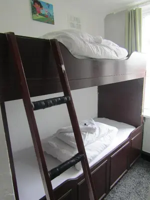 a bunk bed with a ladder next to a bunk bed at Alderley Hotel Blackpool in Blackpool
