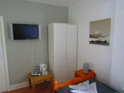 a bedroom with a bed and a tv on the wall at Alderley Hotel Blackpool in Blackpool