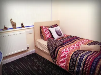 a small bedroom with a bed and a pillow at Renshaw Guest House in Liverpool