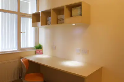 a desk in a room with a chair and a window at Renshaw Guest House in Liverpool