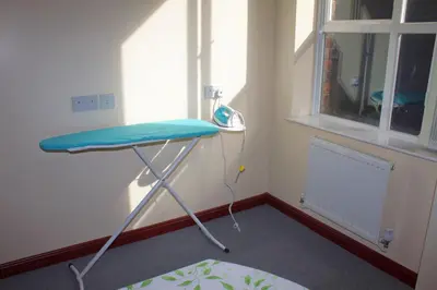 a room with a blue table in a room with a window at Renshaw Guest House in Liverpool