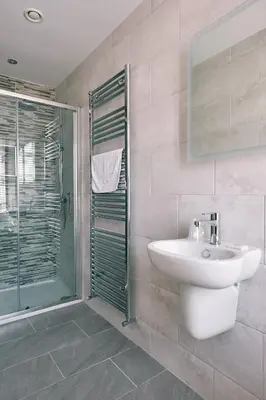 a bathroom with a sink and a glass shower at The Queens Hotel in Lytham St Annes