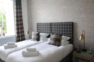 a bedroom with a large bed with two pillows at 1823 Spinning Block in Clitheroe