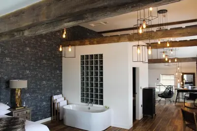 a bedroom with a bath tub in the middle of a room at 1823 Spinning Block in Clitheroe