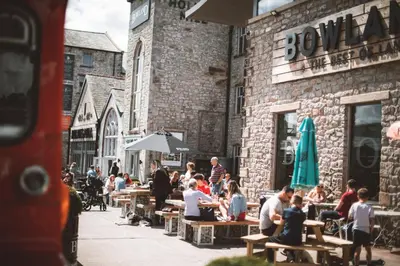 a group of people sitting at tables outside a building at 1823 Spinning Block in Clitheroe