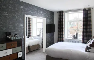 a bedroom with two beds and a window at 1823 Spinning Block in Clitheroe