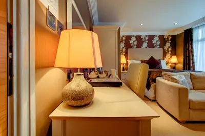 a vase sitting on a table in a bedroom at Number One South Beach in Blackpool