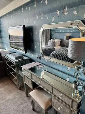 a bedroom with a bed with a mirror and a desk at Number One South Beach in Blackpool