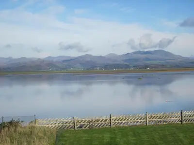 a view of a lake with mountains in the background at HH Accommodation in Millom