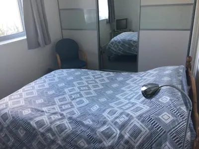 a bedroom with a bed with a computer mouse on it at HH Accommodation in Millom