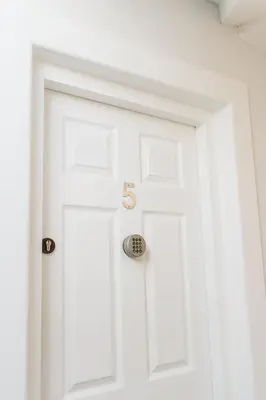 a white door with the number on it at Sweet Suites Lytham in Lytham St Annes