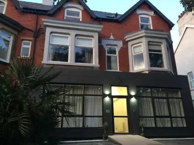 a large red brick house with windows at Sweet Suites Lytham in Lytham St Annes