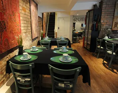 a dining room with a black table and chairs at The Gallery in Blackpool