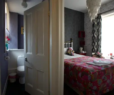 a bedroom with a bed and a window and a door at The Gallery in Blackpool