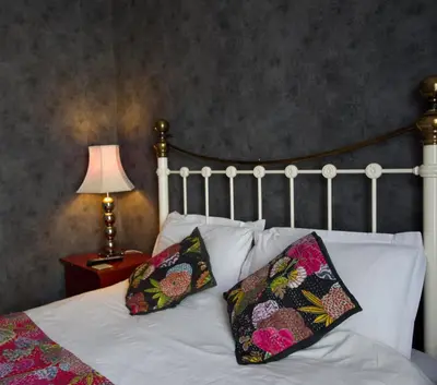 a bedroom with a bed with two pillows and a lamp at The Gallery in Blackpool