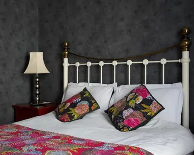 a white bed with two pillows on top of it at The Gallery in Blackpool