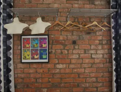 a brick wall with a framed picture and hangers at The Gallery in Blackpool