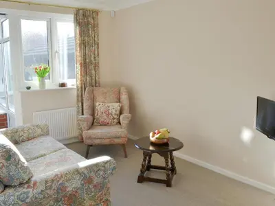 a living room with a couch and a chair and a table at Carmichael in Longridge