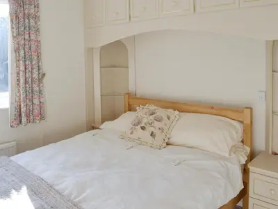 a white bed with a pillow on top of it at Carmichael in Longridge