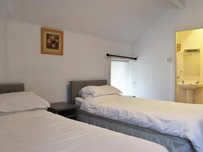 a hotel room with two beds and a sink at Ocean View House in Blackpool
