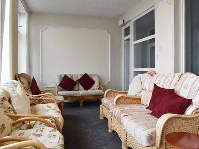 a living room with couches and chairs and a window at Ocean View House in Blackpool