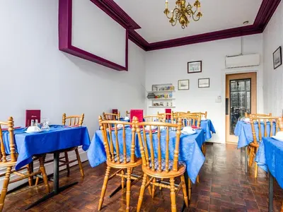 a dining room with blue tables and chairs at Holmeleigh Hotel in Blackpool