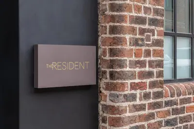 a sign on the side of a brick wall at The Resident Liverpool in Liverpool