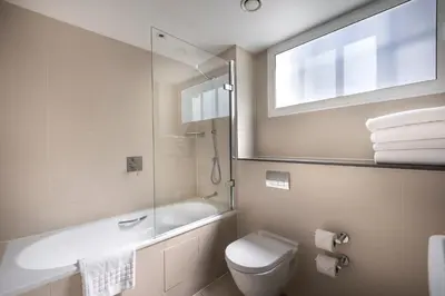 a bathroom with a toilet and a sink and a mirror at The Resident Liverpool in Liverpool