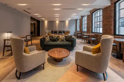 a living room with a couch and chairs and a table at The Resident Liverpool in Liverpool