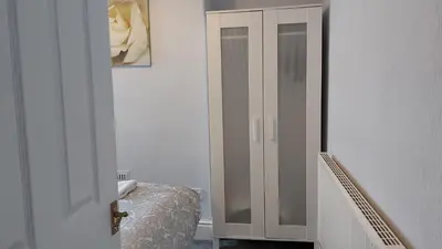 a bedroom with a door leading to a bed at Talton House in Liverpool