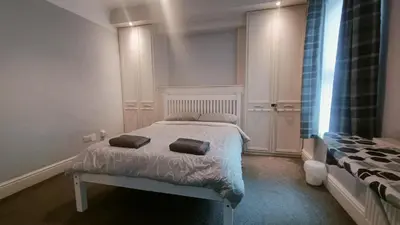 a bedroom with a bed with two pillows on it at Talton House in Liverpool