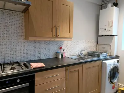 a kitchen with a sink and a stove top oven at Talton House in Liverpool