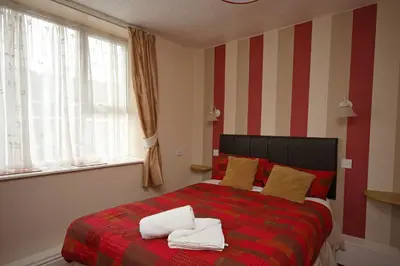 a bedroom with a bed with two towels on it at Boltonia in Blackpool