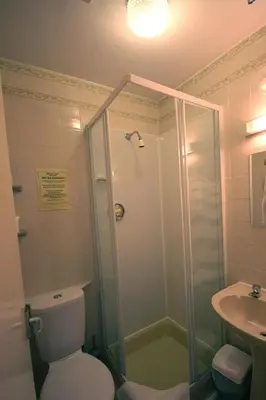 a bathroom with a shower and a toilet and a sink at Boltonia in Blackpool
