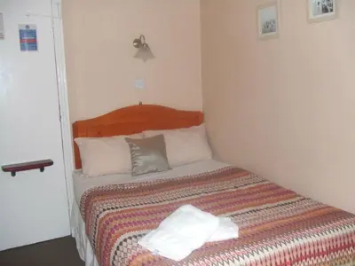 a bedroom with a bed with two towels on it at Boltonia in Blackpool