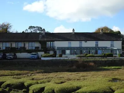 a large white building with cars parked in front of it at The Bay Horse Hotel And Restaurant in Ulverston