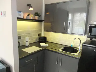 a kitchen with a sink and a counter top at Dewsbury House in Blackpool