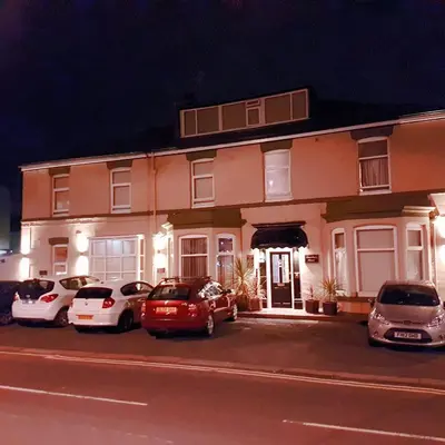 a building with cars parked in front of it at Dewsbury House in Blackpool