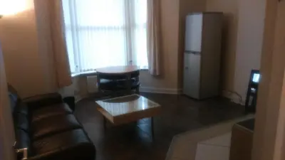 a living room with a couch and a coffee table at MARLEY MANSIONS APARTMENT - Clarendon in Wallasey