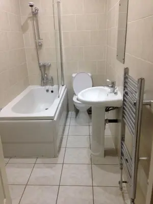 a bathroom with a toilet and a sink and a bath tub at MARLEY MANSIONS APARTMENT - Clarendon in Wallasey