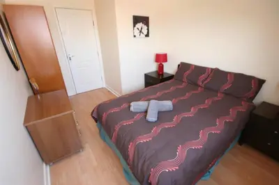a bedroom with a bed with a blue object on it at MARLEY MANSIONs APARTMENTS - KING ST REF : 10/3 in Wallasey