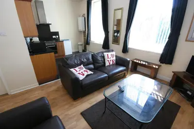 a living room with a leather couch and a coffee table at MARLEY MANSIONs APARTMENTS - KING ST REF : 10/3 in Wallasey