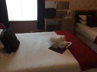 a hotel room with a towel on a bed at The Aberford in Blackpool