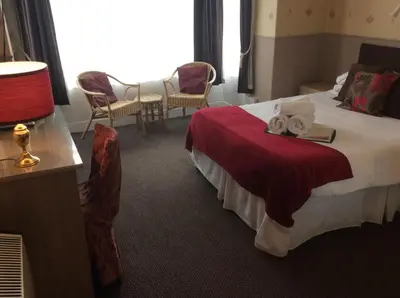 a hotel room with a bed with towels on it at The Aberford in Blackpool