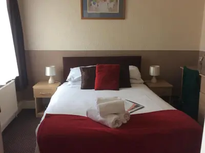 a bedroom with a bed with a book on it at The Aberford in Blackpool