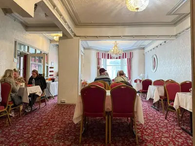 a group of people sitting at tables in a restaurant at The Aberford in Blackpool