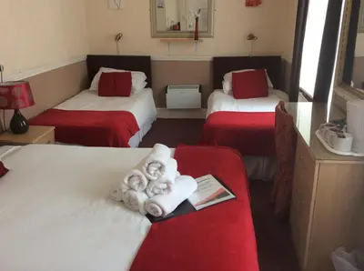 a hotel room with two beds with towels on them at The Aberford in Blackpool