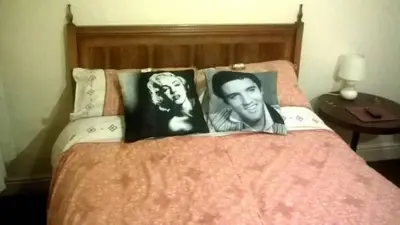 a bed with two black and white photographs on it at The Albert Hotel Near Winter Gardens in Blackpool