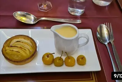 a white plate with a pastry and a cup of coffee at The Albert Hotel Near Winter Gardens in Blackpool
